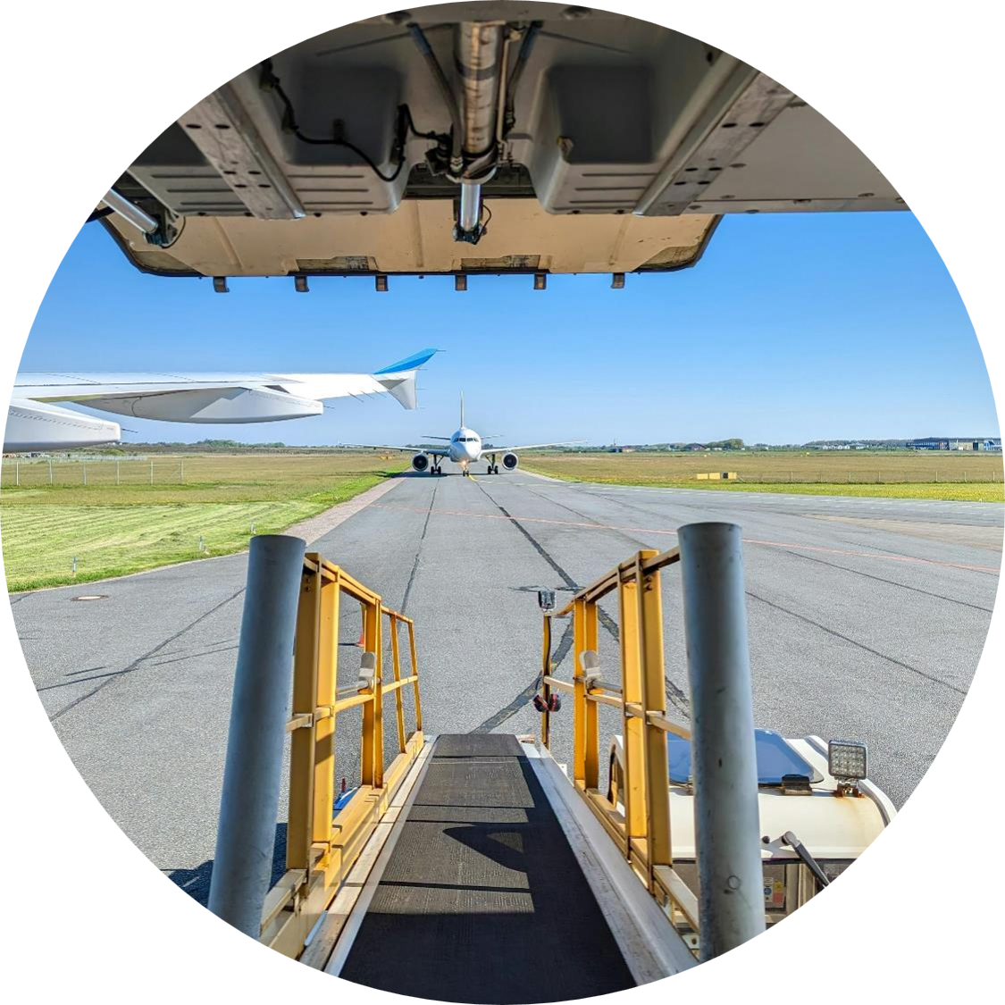 looking at an airplane head on as it moves along the tarmac